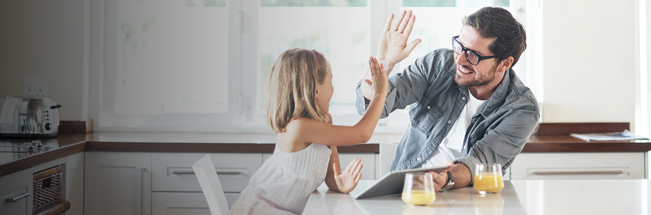 father and daughter high five in kitchen