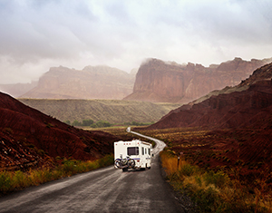 RV driving through red rock canyons
