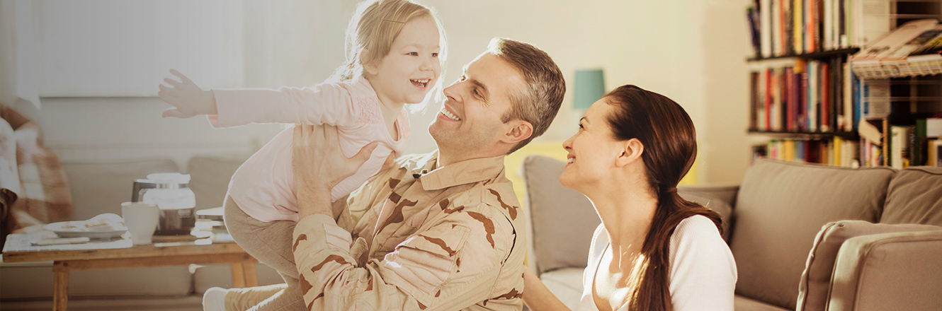 service member and family in living room of home