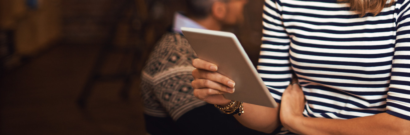 A woman holding a tablet device