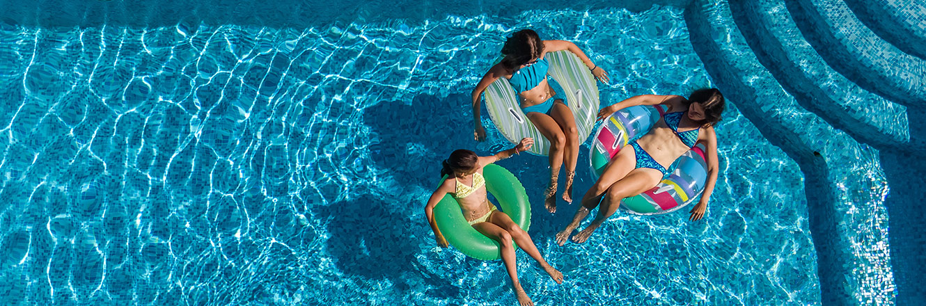 3 women sitting in swimming pool