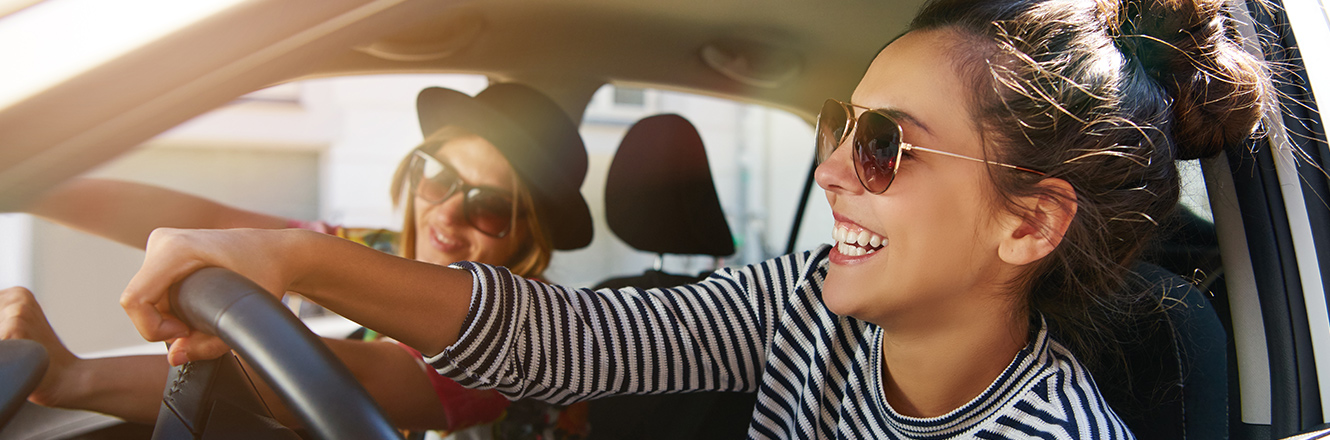 2 young girls driving in car