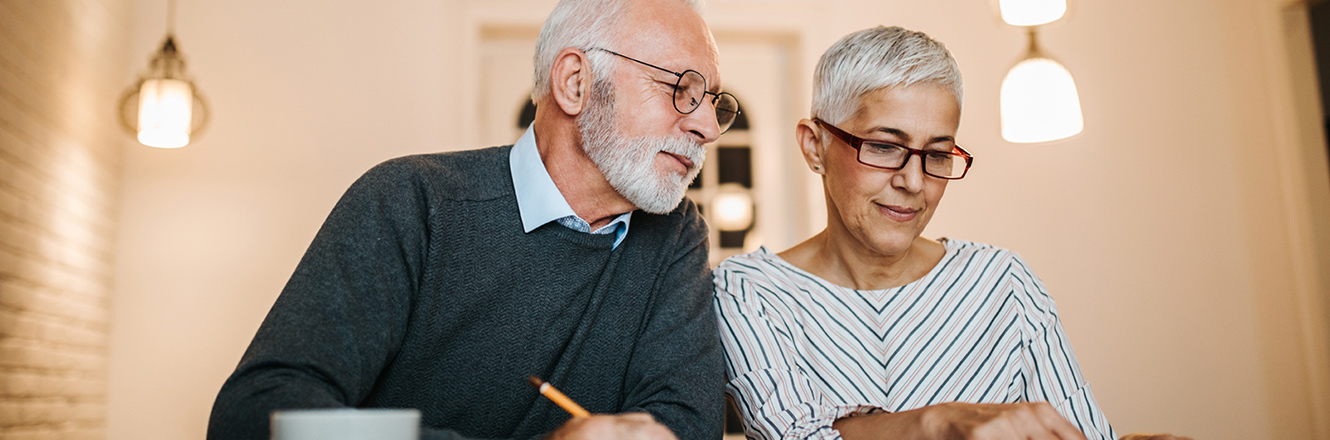 elderly couple working on paper