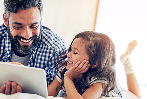 father and daughter using tablet