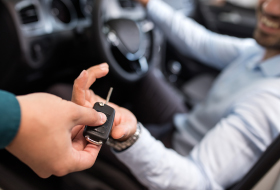 A person handing over car keys