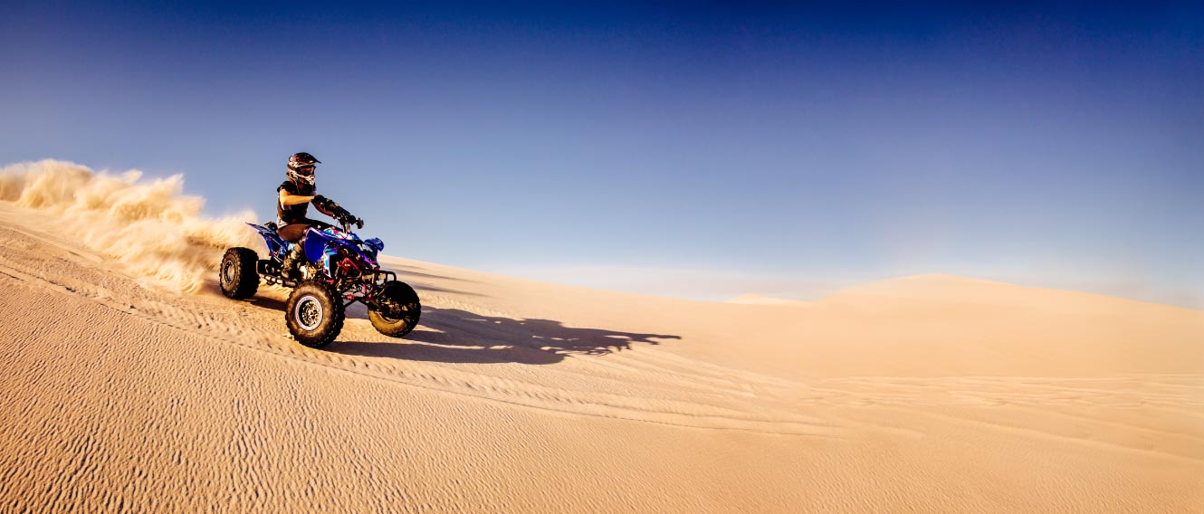 Person riding an ATV in desert