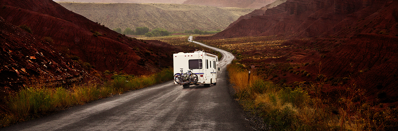 RV driving through red rock canyons