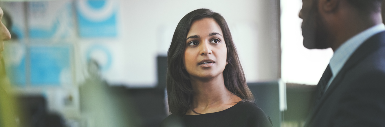 Business woman having a discussion with co-workers