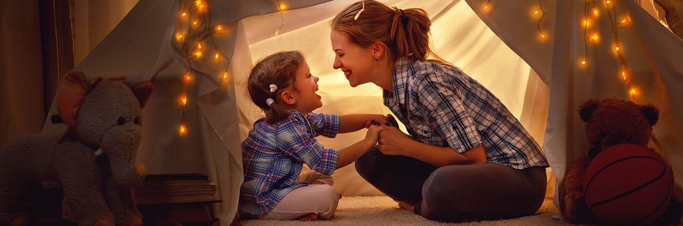 mother and daughter in living room tent