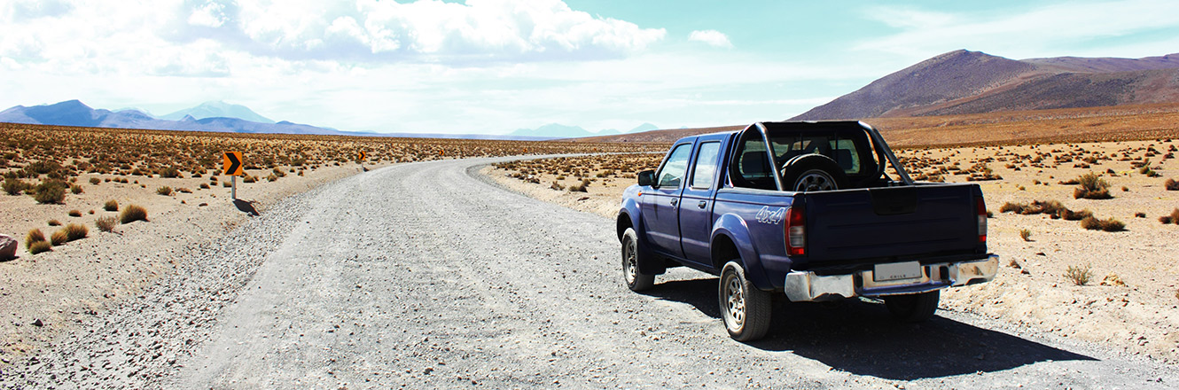 pick up truck parked on a desert road