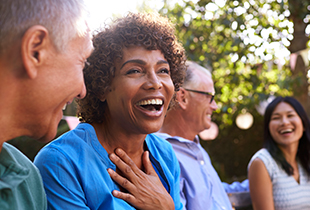 mature friends talking in backyard