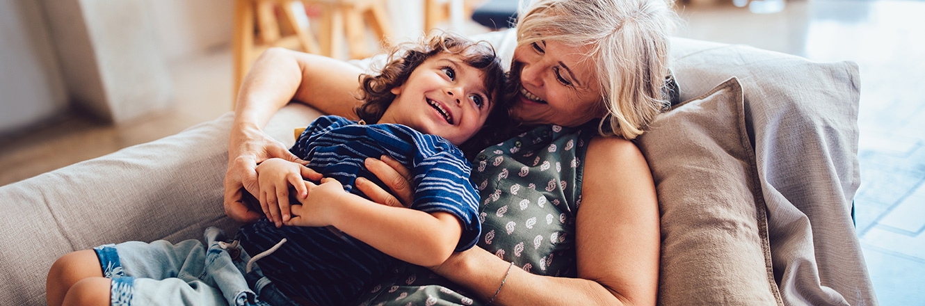 grandmother and grandson sitting on couch