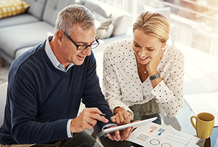 mature couple looking at tablet