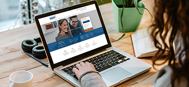 woman visiting Credit Union West website on laptop