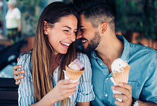 couple sharing ice cream cones