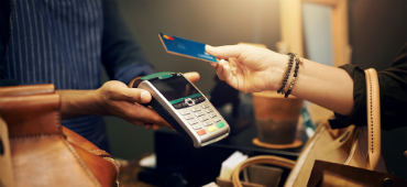 Shopper paying with Credit Union West card featuring new debit card design