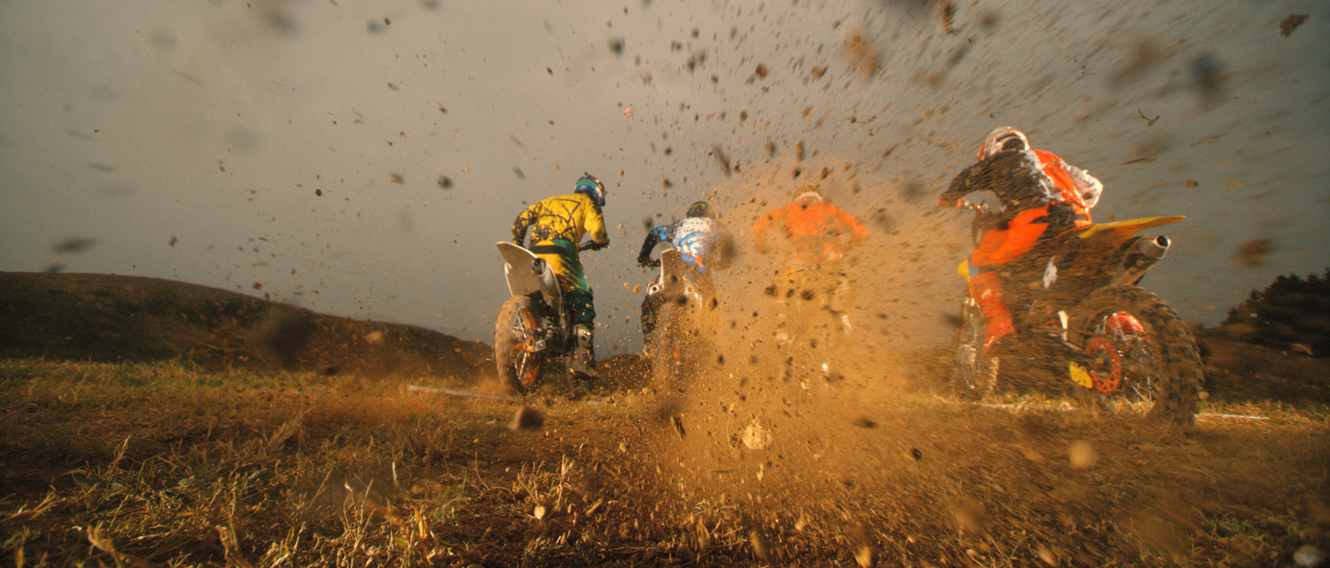Four people dirtbike racing.