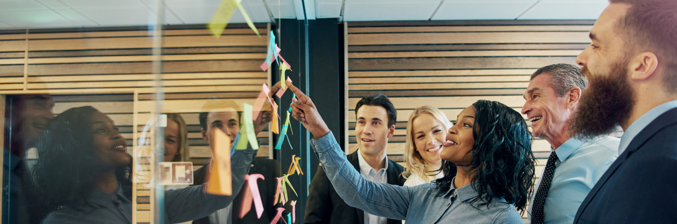 coworkers working with post-it notes