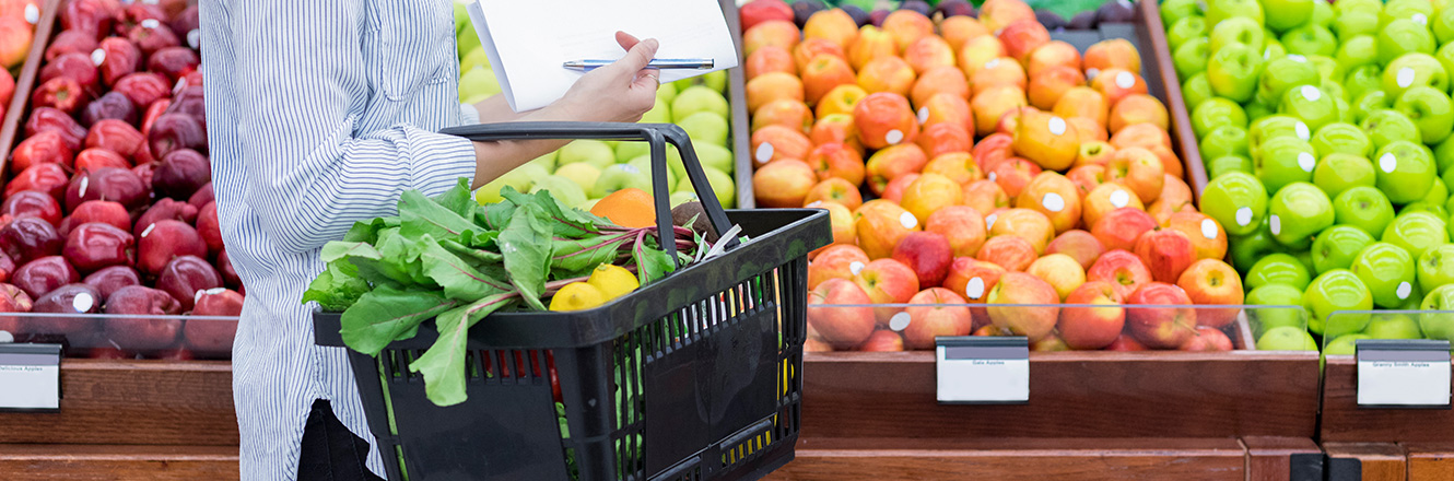 woman grocery shopping in produce