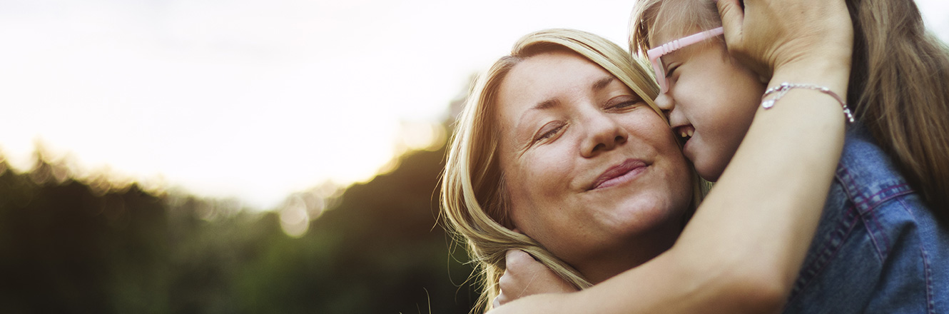 young mother smiling with her daughter 