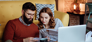 Couple at home going through finances.