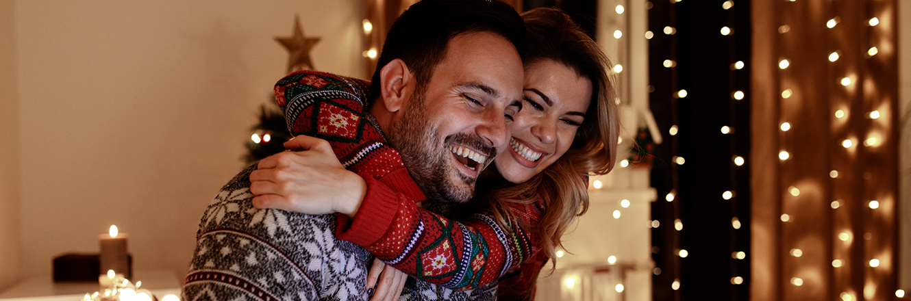 couple hugging in holiday sweater