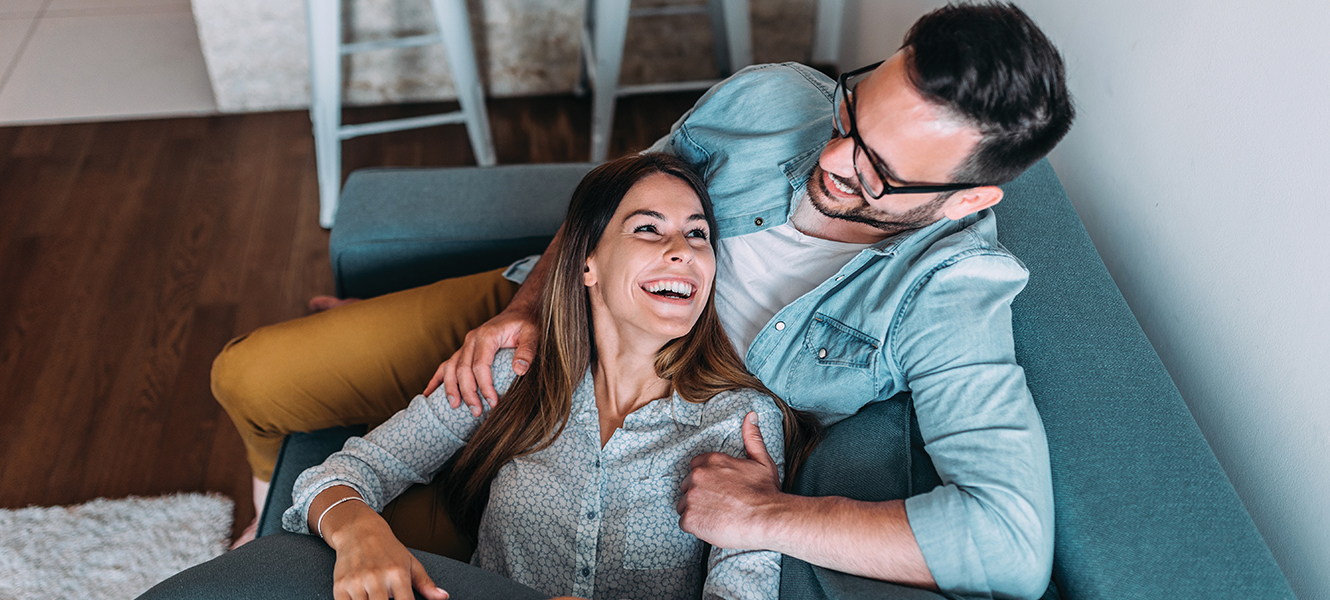 middle age couple sitting on couch