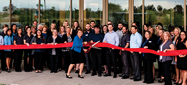 Employees lined up for ribbon cutting ceremony