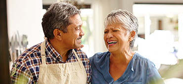 senior couple cooking together in kitchen