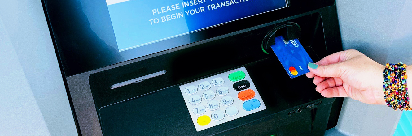 inserting debit card into ATM