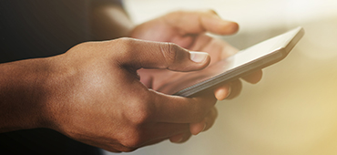 Man holding cell phone typing