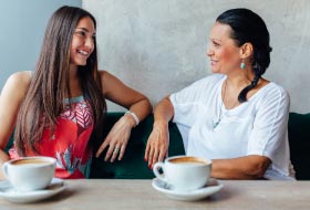 Two women chatting at coffee shop