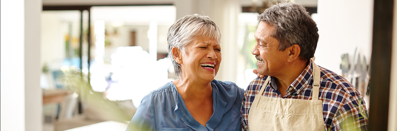 senior couple cooking together in kitchen