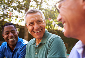 three men talking outside