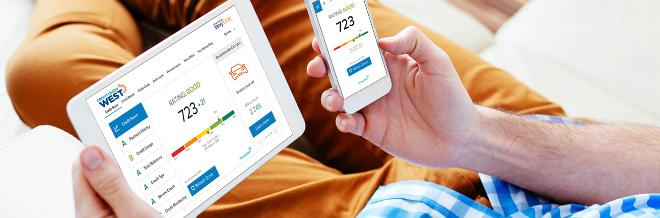 man holding tablet and phone using Savvy Money in Online Banking