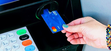 inserting debit card into ATM