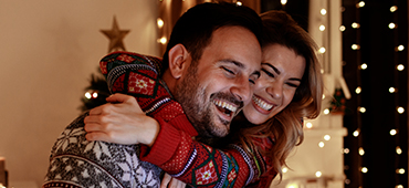 couple hugging in holiday sweater