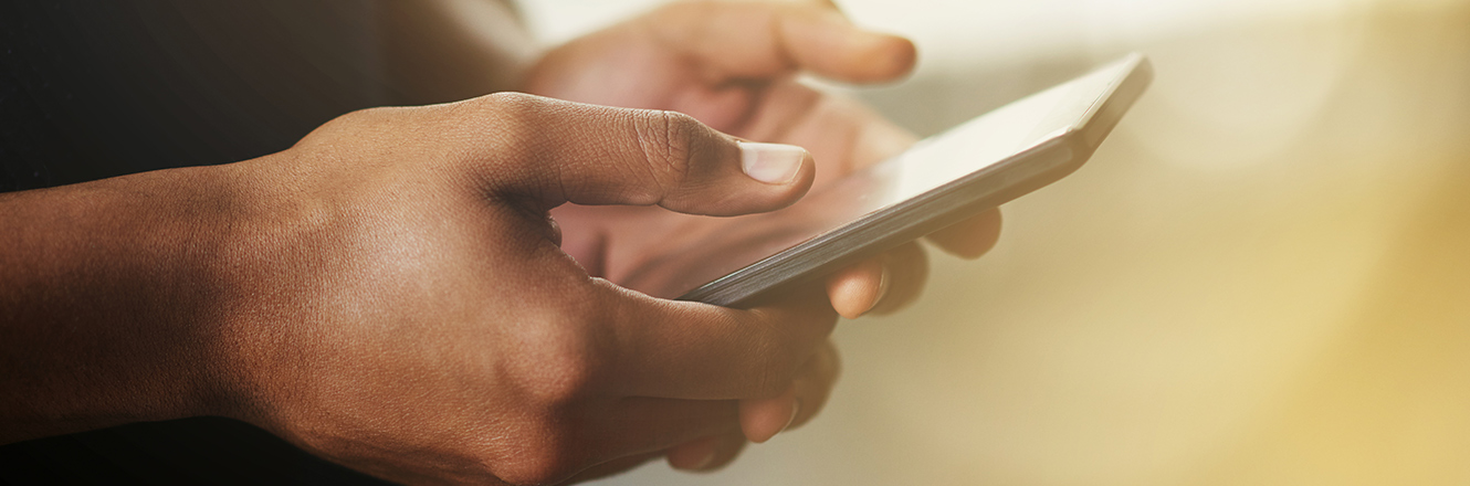 Man holding cell phone typing