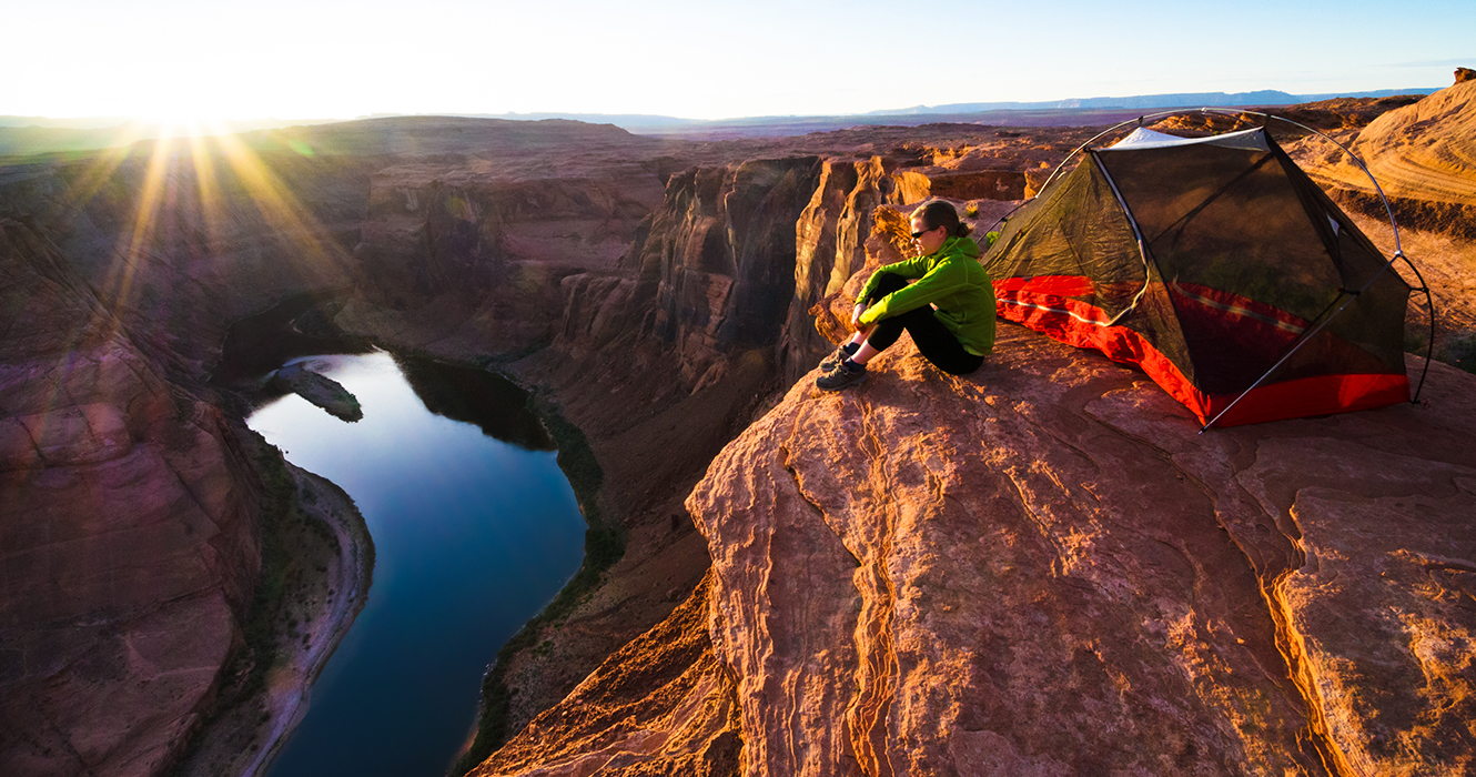 Hiker watching sunset at the Grand Canyon.