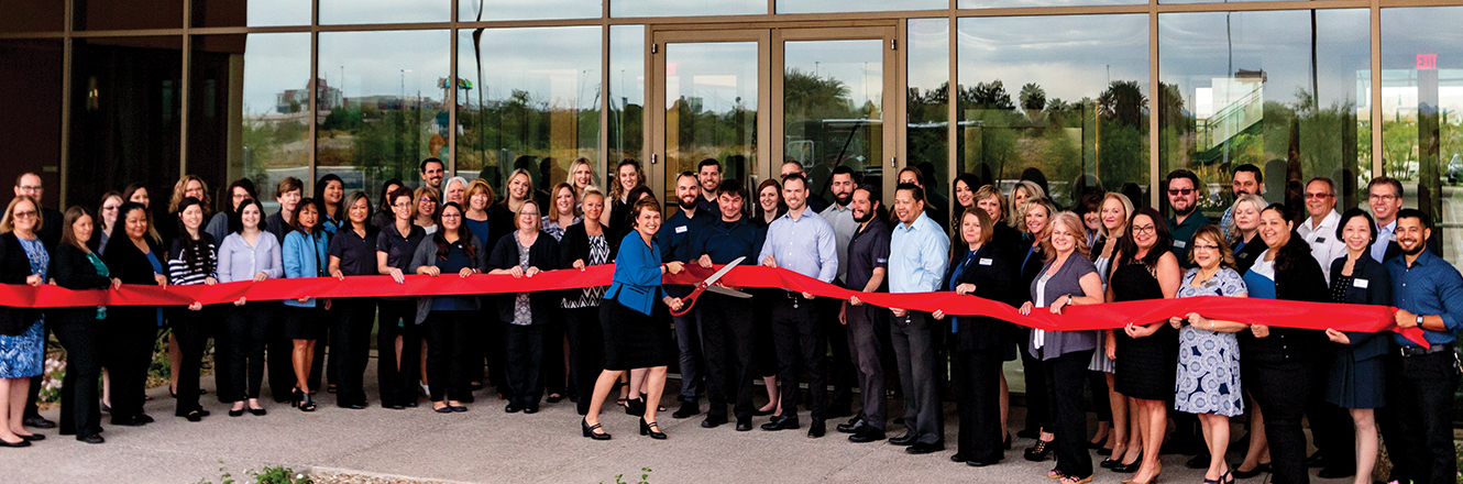 Employees lined up for ribbon cutting ceremony